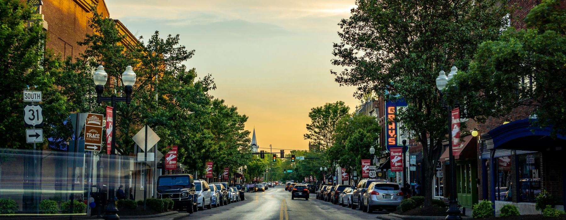 a street with cars and trees